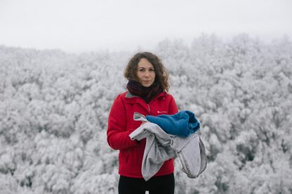 Bosnian Save the Children staff member Alma, posing in the snow with blankets that they always have in the boot of their car to hand out to children and families in need. These photos were taken en route to Vucjak, an unofficial refugee camp in Bihac in northwestern Bosnia and Herzegovina. Vucjak camp was closed shortly after this visit.