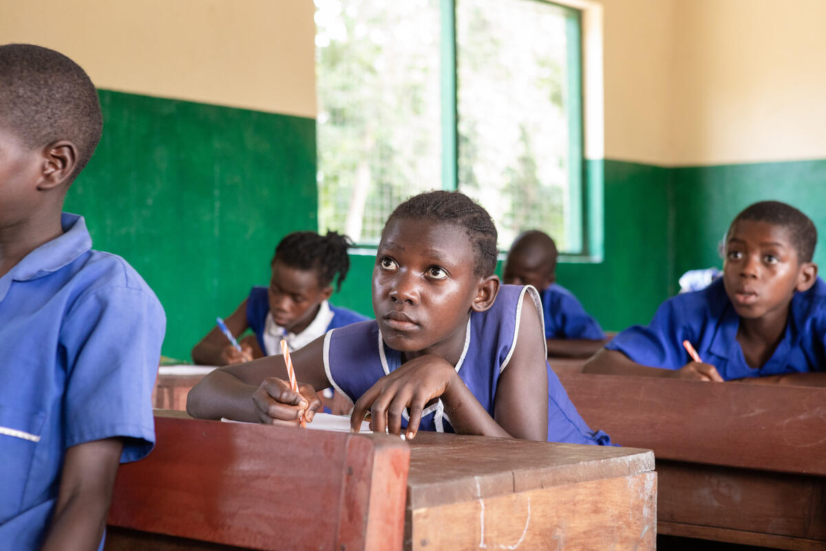 In a remote village by a river in Sierra Leone, children are going to great lengths to get to school.

One of these children is Tenneh, a 13-year-old determined to get a good education. Her journey to school isn’t a typical one. She starts the day by crossing the river in her canoe, no matter what the weather brings.

“When I am sitting in my boat on the way to school and the wind is blowing, I park the boat and wait for the wind to stop. Then I jump back into my boat quickly so I can get to school early,” says Tenneh.

Her village is only accessible by boat. The river is a way of life for families, from washing clothes in the water to catching fish to eat.

“I want to be educated and help my parents,” Tenneh says. She wants to be a nurse, thanks to her hard work and supportive teacher. “When the teacher gives us homework and we submit it, he corrects us nicely. He takes good care of us,” she says.

Now Tenneh’s school stands out, with students achieving above the national average in their exams.

We are supporting schools in Sierra Leone so children can continue to learn and play. We provide uniforms, books, and desks. Our teacher training programme makes sure that girls like Tenneh can stay in school and reach their potential.

Strong quotes

“I like the school. The school is beautiful, and the teacher likes me. Whatever we need they will provide for us.”

“When the teacher gives us homework and we submit it, he corrects us nicely. In the morning, he walks around just to make sure that we are all in school. He takes good care of us.”

“If I was a teacher, I would encourage pupils to come to school.”

“When I am sitting in my boat on the way to school and the wind is blowing. I go and park the boat and wait for the wind to cease, then I jump into my boat and cross over. I hurry up quickly so I can get to school early.”

“Sometimes my hands get tired when I get in the middle of the river. I have to stop the paddling of the boat and