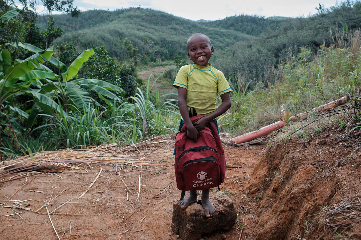 Christian 9, and his seven siblings and a nephew, live with heir parents in Mananjary district. Christian, together with two of his siblings study at the public school but due to lack of money, the elder one was forced to interrupt his studies. 
After Cyclone Batsirai, life for Christian's family got worse: the house was destroyed, school supplies got wet, there was no money for food because there was no work. To cope with this, the family ate bananas, cassava and 3kg of rice for a month. His teacher gave Christian a notebook to write down lessons as he lost all his school supplies.
With the support of Save the Children, Christian and his siblings benefited from school kits including a school bag, pens, chalk, notebooks, a slate and rulers. Christian likes to draw so he was very happy with the new school supplies. In addition, they could also buy items for their daily needs with the financial support given by Save the Children.
